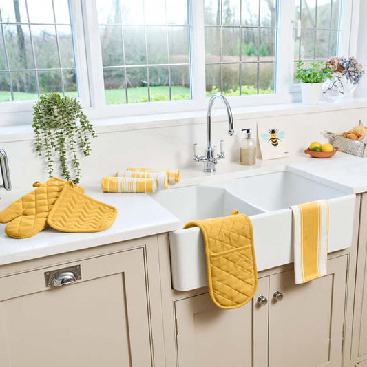 Dexam - Love Colour Tea Towel - Ochre displayed in a bright kitchen with matching accessories.