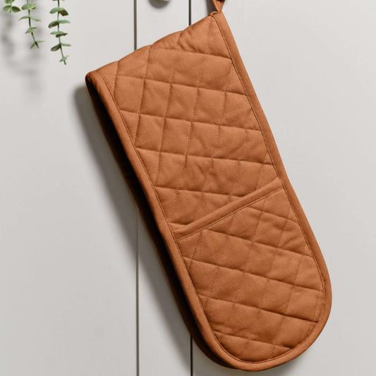 Double Oven Gloves - Dexam - Love Colour - Terracotta hanging on a cabinet, made from hardwearing cotton with a quilted design.
