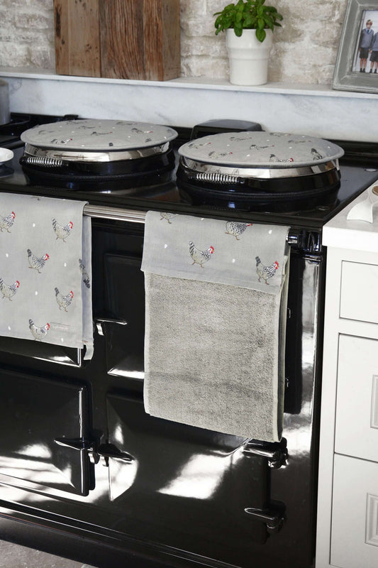 Sophie Allport "Chicken" Chefs Pad For Use With Aga Range Cookers displayed on stovetop with speckled Maran hens design.