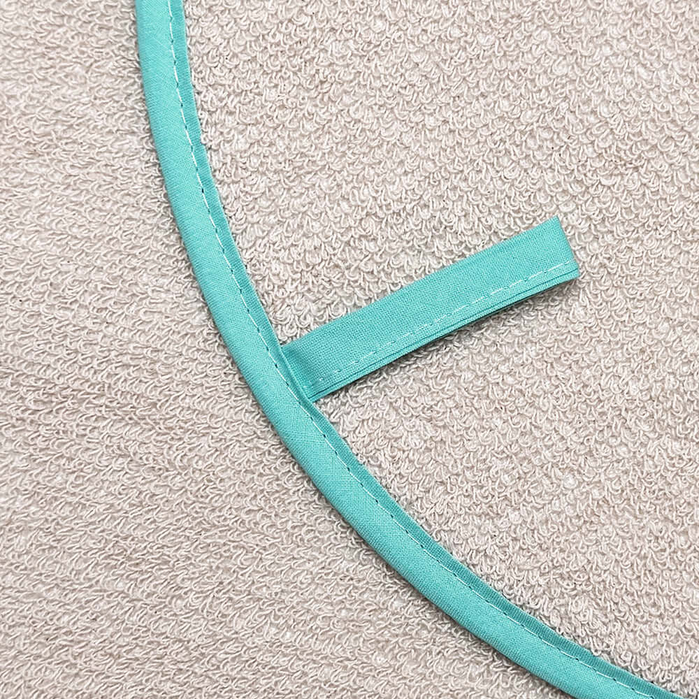 Becky Alexander Flying Tiger & Zebra Chefs Pad for use with Aga Range Cookers showing minty blue-green binding and hanging loop.