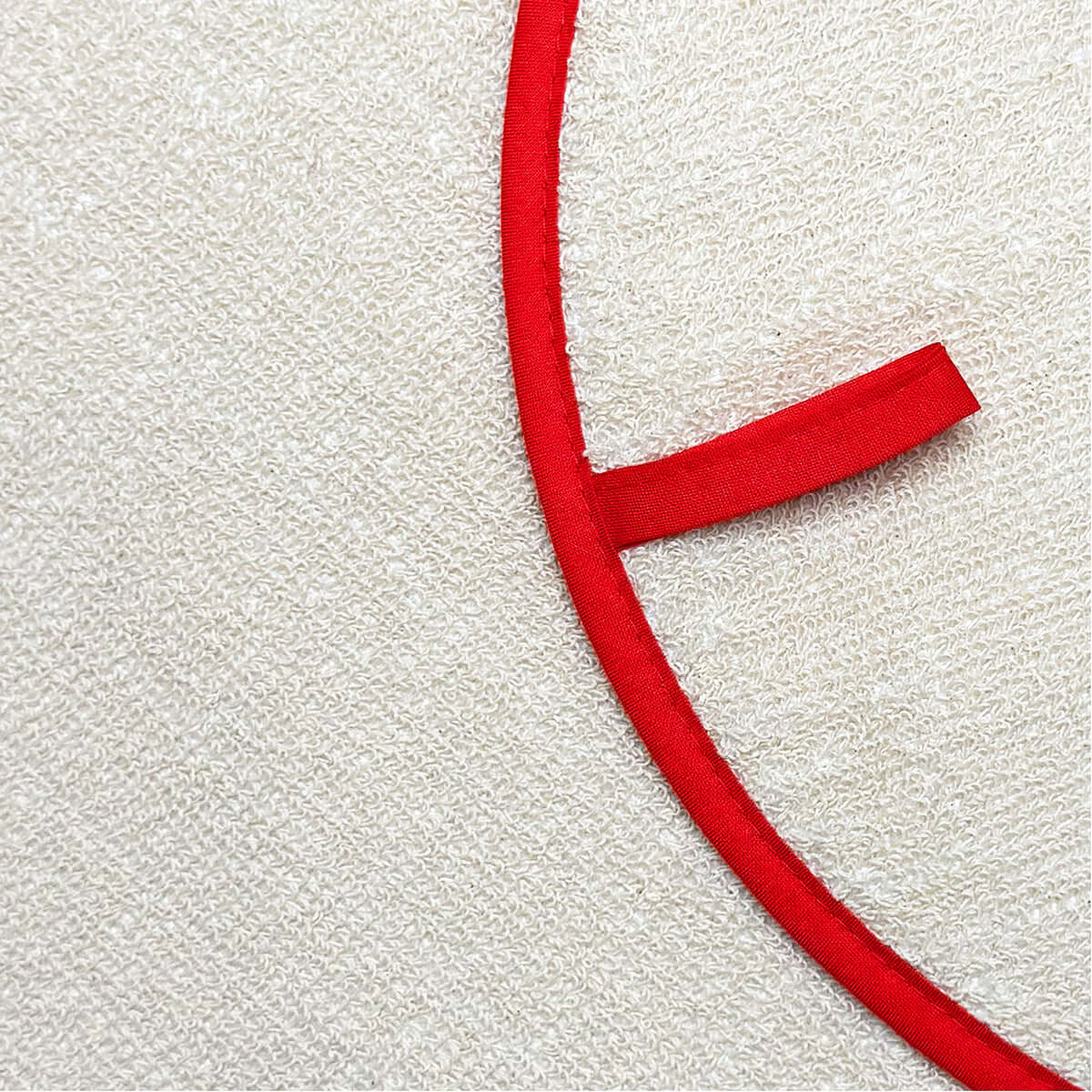 Becky Alexander Pink & Red Wiggly Chefs Pad for use with Aga Range Cookers close-up showing cream terry towelling and red binding.