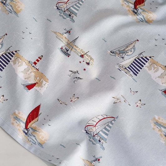 Sophie Allport "Coastal Boats" Tea Towel featuring nautical drawings on a pale blue background, depicting boats and sea birds.