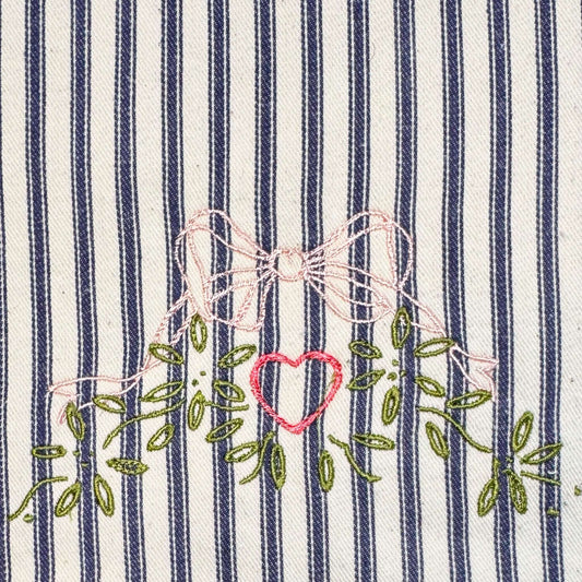 Ticking Stripe "Embroidered Bow" Chefs Pad for use with Aga Range Cookers showing embroidered bow design.