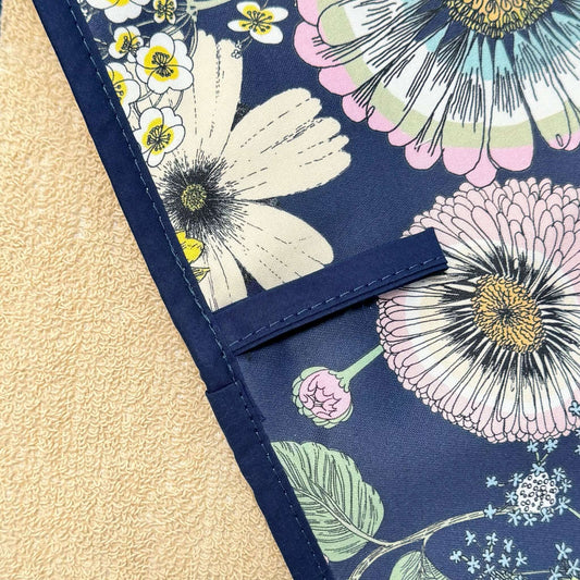 Close-up of Michael Angove Navy Sunflower Double Oven Glove with floral design and cream terry towelling background.