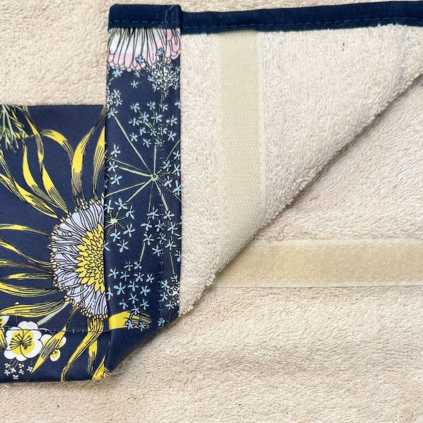 Michael Angove Navy Sunflower Roller Hand Towel featuring hand-drawn sunflower design on navy fabric with cream towel.