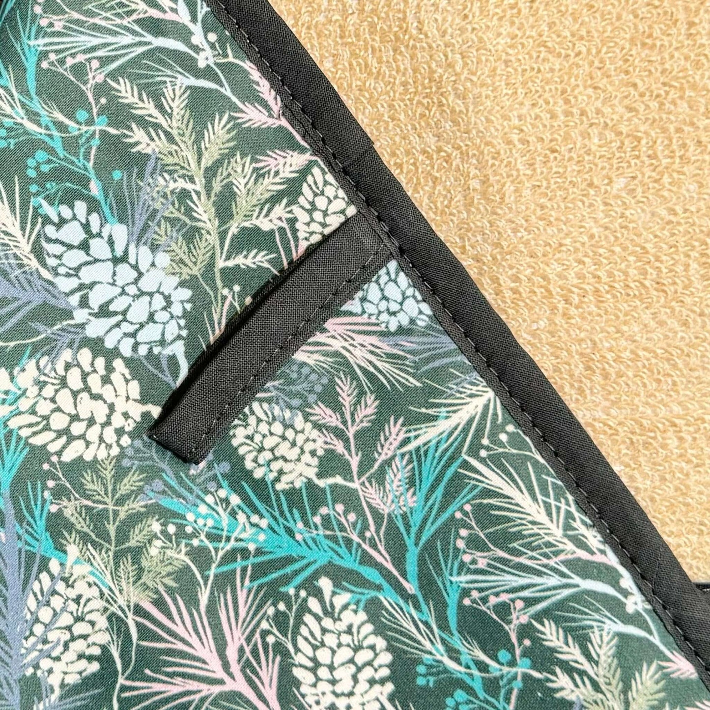 Crisp & Dene Winter Spruce Double Oven Glove featuring a floral design of pine cones and winter foliage.